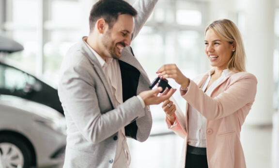 Two dealership employees talking